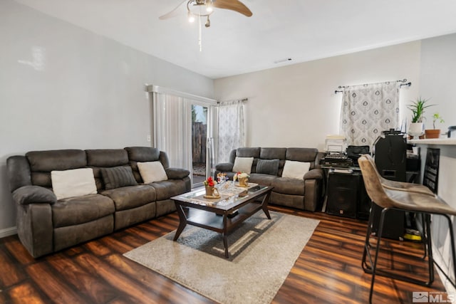 living area featuring dark wood-style floors, visible vents, and ceiling fan