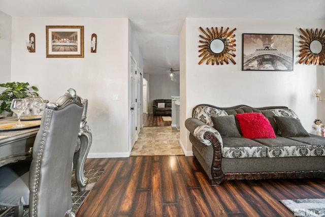 living room featuring a ceiling fan, wood finished floors, and baseboards