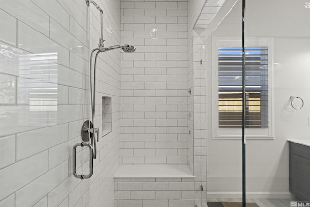 bathroom with a stall shower and vanity