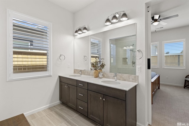 full bath featuring a sink, tiled shower, ensuite bathroom, and a ceiling fan