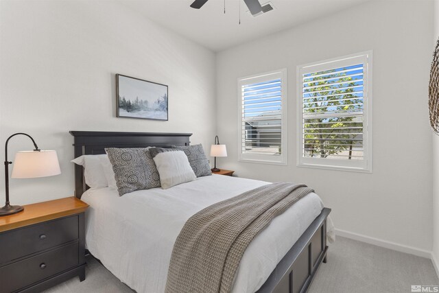 bedroom featuring visible vents, baseboards, light colored carpet, and ceiling fan