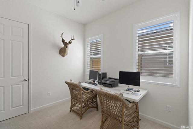 carpeted office with baseboards and ceiling fan