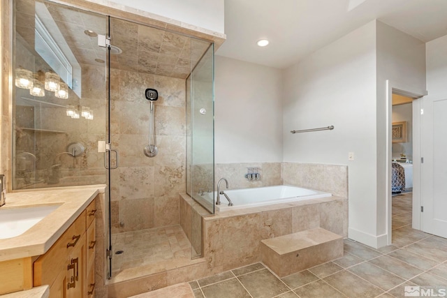full bathroom featuring vanity, a bath, a shower stall, and tile patterned flooring