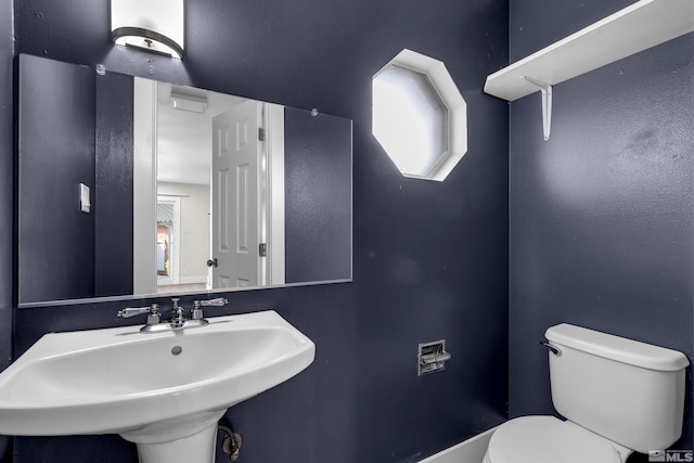 bathroom with toilet and a sink