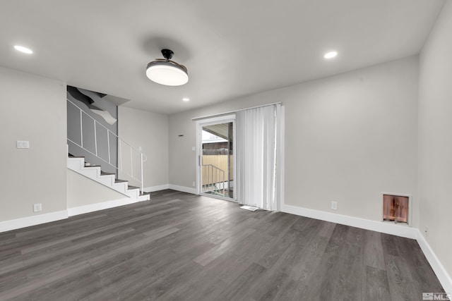 unfurnished room featuring stairs, baseboards, recessed lighting, and dark wood-style flooring
