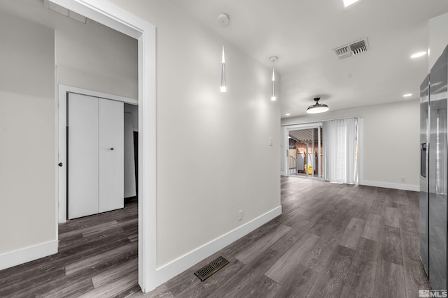 hall with recessed lighting, visible vents, baseboards, and dark wood-style flooring