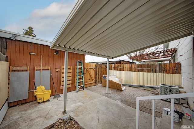 view of patio featuring central air condition unit and fence