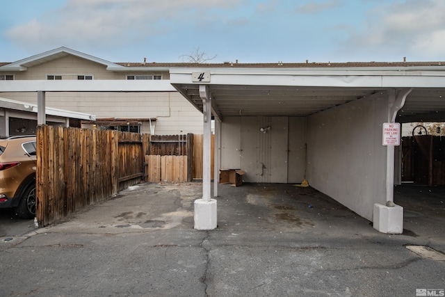 view of parking / parking lot featuring fence