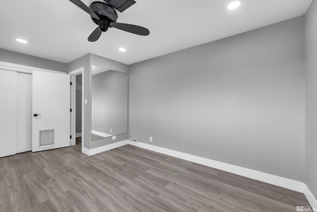 unfurnished bedroom with visible vents, recessed lighting, wood finished floors, and baseboards