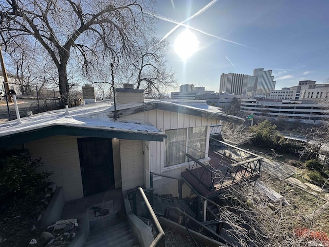 exterior space with a city view and a chimney