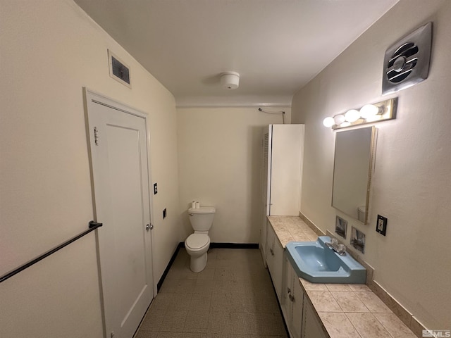 bathroom with visible vents, baseboards, toilet, and vanity