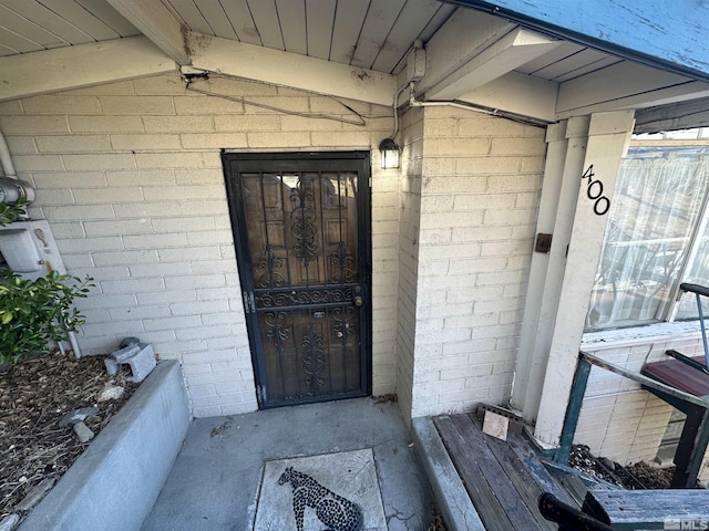 property entrance with brick siding