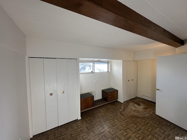 unfurnished bedroom featuring beam ceiling and baseboard heating