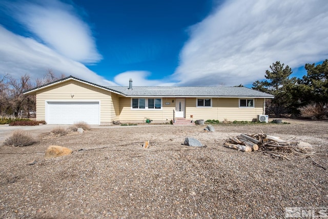 ranch-style house featuring a garage and driveway