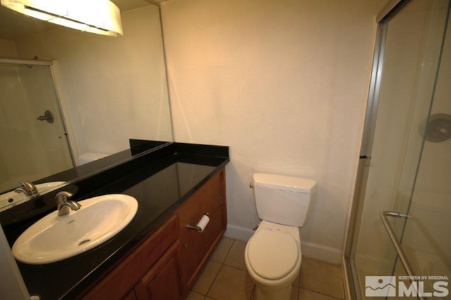full bathroom featuring a shower stall, toilet, vanity, and baseboards