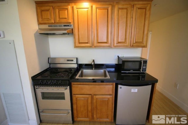 kitchen with a sink, electric range, dark countertops, dishwasher, and under cabinet range hood