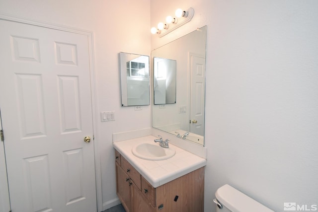 bathroom featuring toilet and vanity