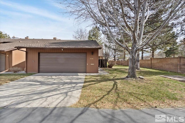 garage with concrete driveway and fence