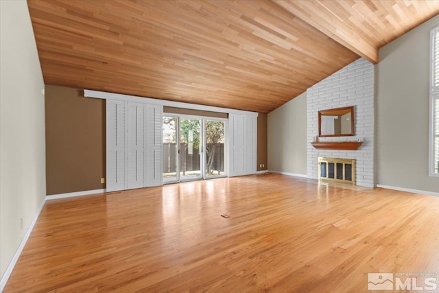 unfurnished living room featuring a brick fireplace, vaulted ceiling with beams, baseboards, wooden ceiling, and wood finished floors