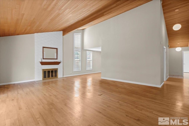 unfurnished living room featuring wood ceiling, wood finished floors, baseboards, and high vaulted ceiling