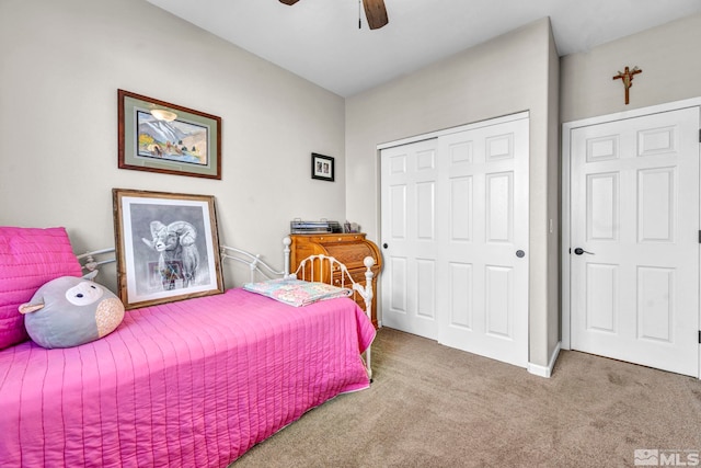 carpeted bedroom with a closet and ceiling fan