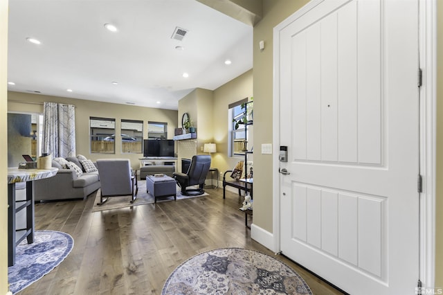 foyer featuring dark wood-type flooring, recessed lighting, a healthy amount of sunlight, and visible vents