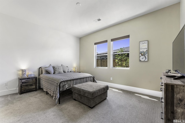 carpeted bedroom with visible vents and baseboards