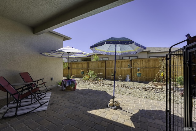 view of patio featuring fence