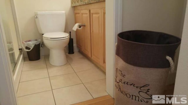 full bathroom featuring tile patterned floors, toilet, and walk in shower