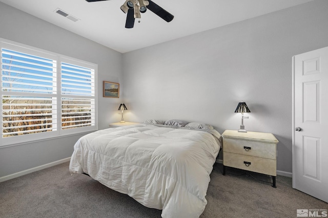 carpeted bedroom with baseboards, ceiling fan, and visible vents