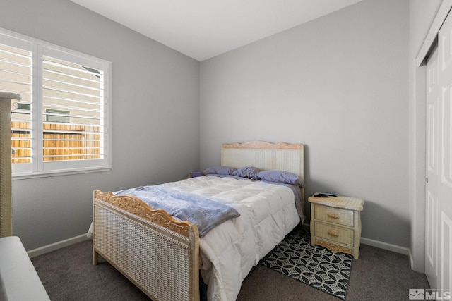 bedroom with a closet, carpet floors, and baseboards