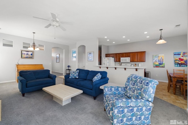 living area with visible vents, baseboards, recessed lighting, a ceiling fan, and arched walkways