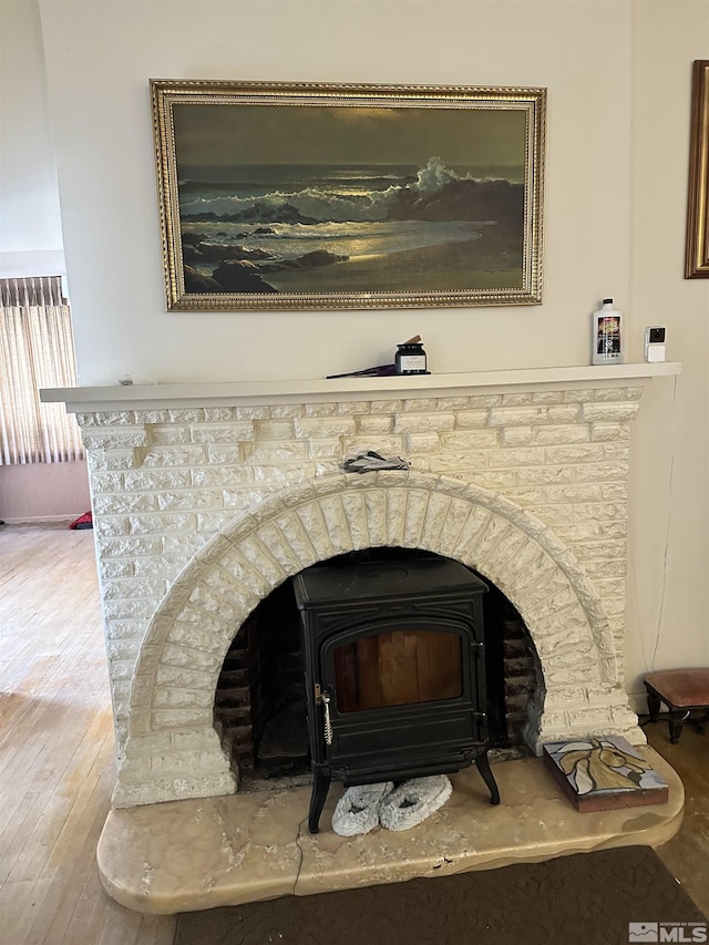 details featuring wood finished floors and a wood stove