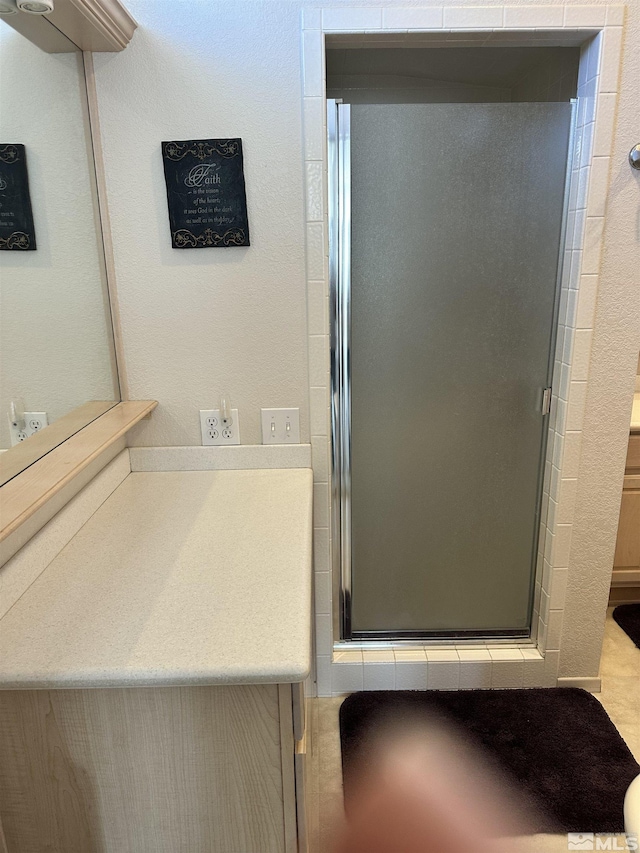 bathroom featuring vanity and a stall shower