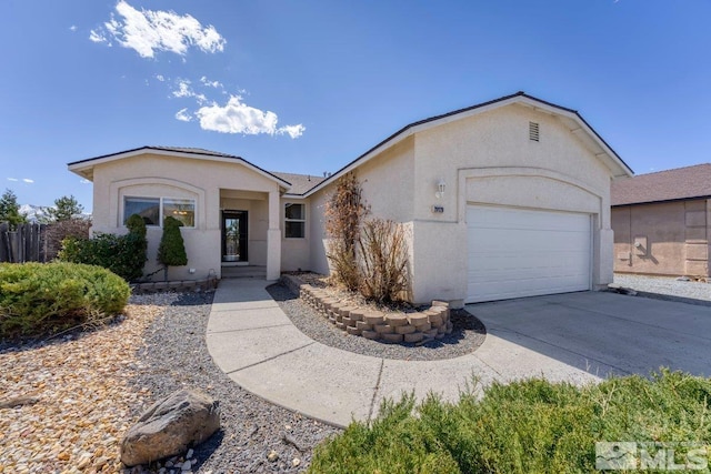 view of front facade featuring concrete driveway, stucco siding, and an attached garage