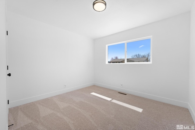 unfurnished room featuring carpet, baseboards, and visible vents