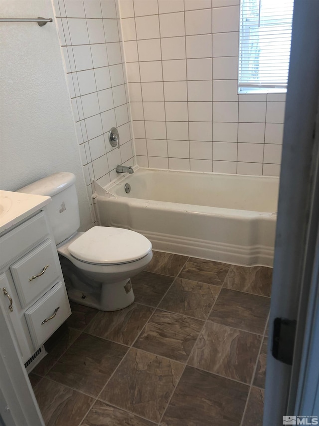 full bathroom with washtub / shower combination, toilet, and vanity