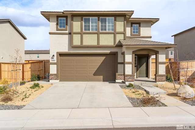 view of front facade featuring stucco siding, an attached garage, fence, and concrete driveway