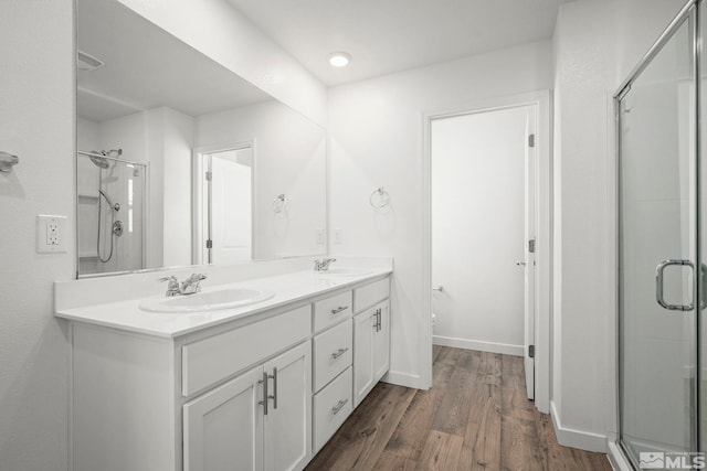 bathroom featuring a shower stall and a sink