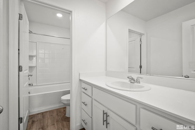 full bathroom featuring tub / shower combination, wood finished floors, toilet, and vanity