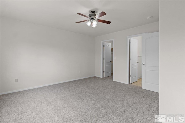 unfurnished bedroom with baseboards, ceiling fan, and light colored carpet