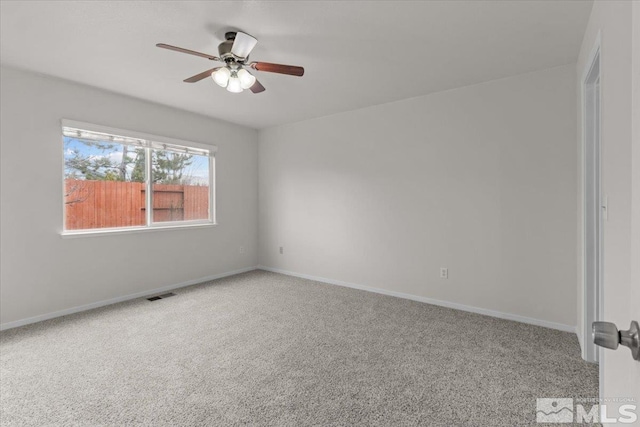 unfurnished room with baseboards, carpet floors, ceiling fan, and visible vents