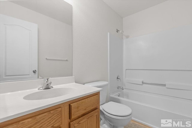 full bathroom with bathtub / shower combination, toilet, and vanity