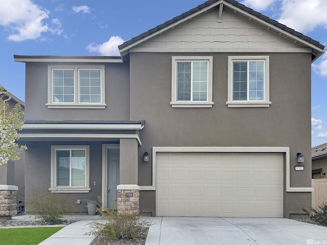 traditional home featuring stucco siding, driveway, and a garage