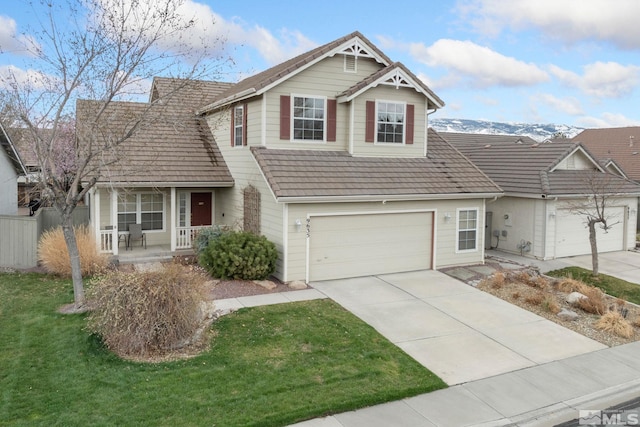 view of front of property featuring covered porch, concrete driveway, fence, a front lawn, and a garage