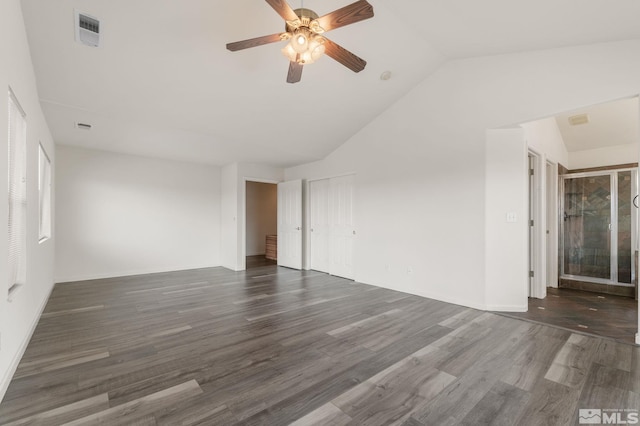 spare room featuring visible vents, vaulted ceiling, a ceiling fan, and wood finished floors