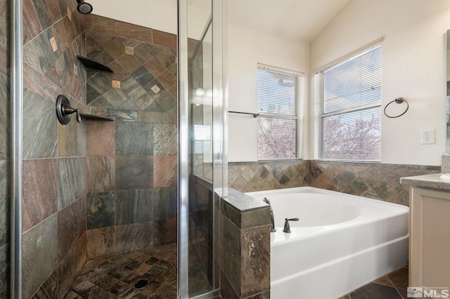 full bathroom with a garden tub, a stall shower, tile patterned flooring, and vanity