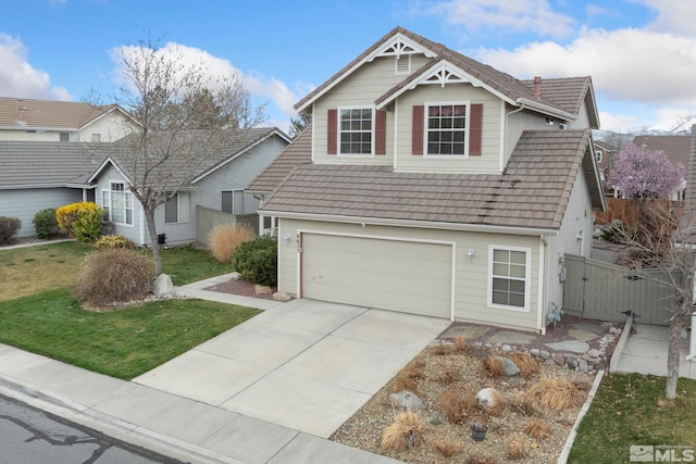 view of front of property featuring fence, driveway, a gate, a front yard, and a garage