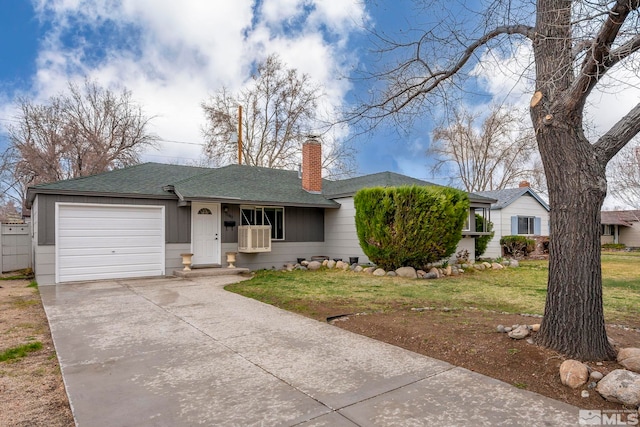 ranch-style house featuring a chimney, a garage, concrete driveway, a front lawn, and roof with shingles