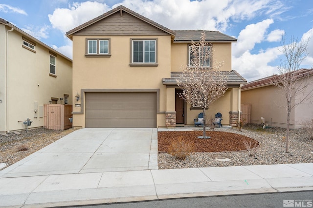 traditional home featuring a tiled roof, a garage, concrete driveway, and stucco siding